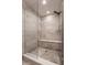 Modern shower with stone tile, glass door, and built-in bench at 222 E 71St St, Indianapolis, IN 46220