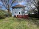 Backyard view of the two-story home with a red deck and a lush green lawn at 2250 N Capitol Ave, Indianapolis, IN 46208