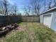 View of backyard with a newly constructed fence and pile of logs in the corner at 2250 N Capitol Ave, Indianapolis, IN 46208