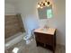 Tiled shower/tub, toilet, and vanity with light countertop can be found inside this bathroom at 2250 N Capitol Ave, Indianapolis, IN 46208