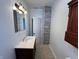 Modern bathroom featuring tiled floors, a vanity sink, modern fixtures, and a large mirror at 2250 N Capitol Ave, Indianapolis, IN 46208