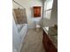 Bathroom with tub and shower, cherry vanity, granite counters, cherry medicine cabinet, and window at 2250 N Capitol Ave, Indianapolis, IN 46208