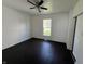 A clean, bright bedroom with hardwood floors, a ceiling fan, and a window with natural light at 2250 N Capitol Ave, Indianapolis, IN 46208