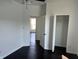 Bright bedroom featuring hardwood floors, an open closet, and an open doorway at 2250 N Capitol Ave, Indianapolis, IN 46208