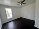 The bedroom features dark hardwood floors, a ceiling fan and a large window at 2250 N Capitol Ave, Indianapolis, IN 46208