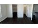 Bedroom featuring two closets, dark hardwood floors, and white walls and trim at 2250 N Capitol Ave, Indianapolis, IN 46208