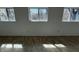 Sunlit bedroom with warm tile flooring and three windows offering a view of the outdoors at 2250 N Capitol Ave, Indianapolis, IN 46208