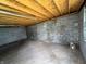 Empty garage interior with concrete block walls, concrete floor and exposed wood rafters at 2250 N Capitol Ave, Indianapolis, IN 46208