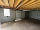 Bare garage interior with concrete block walls, concrete floor and exposed wood rafters at 2250 N Capitol Ave, Indianapolis, IN 46208