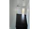 Hallway features dark hardwood floors and white walls, leading to rooms with natural light at 2250 N Capitol Ave, Indianapolis, IN 46208