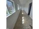 Bright hallway with tiled flooring and multiple windows providing natural light and outdoor views at 2250 N Capitol Ave, Indianapolis, IN 46208