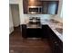 A kitchen with stainless steel appliances, granite countertops, and dark wood cabinets at 2250 N Capitol Ave, Indianapolis, IN 46208