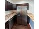 The kitchen features stainless steel appliances, granite countertops, and dark wood cabinets at 2250 N Capitol Ave, Indianapolis, IN 46208