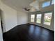 A spacious living room features dark wood floors, white walls, tray ceilings, and multiple windows at 2250 N Capitol Ave, Indianapolis, IN 46208