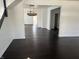 Open-concept living room with dark hardwood floors and white walls at 2250 N Capitol Ave, Indianapolis, IN 46208
