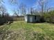 Small shed featuring door, window and light blue siding, nestled in a green lawn with a wooden fence at 2250 N Capitol Ave, Indianapolis, IN 46208
