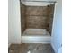 Bathroom showcasing a tub and shower combo, tiled walls, and fixtures at 2250 N Capitol Ave, Indianapolis, IN 46208