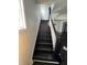 Dark stained wood staircase with white railing and trim at 2250 N Capitol Ave, Indianapolis, IN 46208