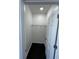 A single shelf lines the top of this walk-in closet with dark hardwood floors at 2250 N Capitol Ave, Indianapolis, IN 46208