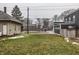 Residential lot featuring green lawn and the rear of two-story, dark gray house at 2329 Shelby St, Indianapolis, IN 46203