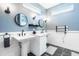 Chic bathroom with dual pedestal sinks, contemporary mirrors, and elegant lighting fixtures at 2329 Shelby St, Indianapolis, IN 46203