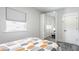 Stylish bedroom with a mirrored wardrobe, natural light, and a view of the exterior at 2329 Shelby St, Indianapolis, IN 46203