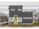 Modern two-story building with gray siding and yellow door offering a contemporary architectural design at 2329 Shelby St, Indianapolis, IN 46203