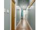 Hallway with hardwood floors, recessed lighting, and a series of doors leading to various rooms at 2329 Shelby St, Indianapolis, IN 46203