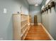 Hallway features hardwood floors, storage cabinets, and decorative touches for a welcoming and organized space at 2329 Shelby St, Indianapolis, IN 46203