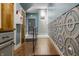Well-lit hallway with decorative wall paneling, access to multiple doors, and hardwood floors at 2329 Shelby St, Indianapolis, IN 46203