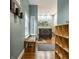 Hallway features hardwood floors, a wooden bench by the window, and view into a bright, stylish area at 2329 Shelby St, Indianapolis, IN 46203