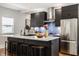 Modern kitchen with a large island, stainless steel appliances, and a stylish backsplash at 2329 Shelby St, Indianapolis, IN 46203