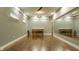 Bright studio featuring hardwood floors, a large mirror, and built in wall shelving at 2329 Shelby St, Indianapolis, IN 46203
