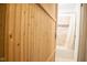 Wooden barn door opening to the bathroom with modern neutral colored tile in the background at 248 Parkview Dr, Whiteland, IN 46184