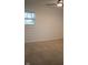 A bright bedroom features neutral carpet, a window offering natural light, and a clean and simple design at 248 Parkview Dr, Whiteland, IN 46184