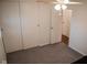 Bedroom with gray carpet, ceiling fan with light, and closet space, offering practical storage solutions at 248 Parkview Dr, Whiteland, IN 46184