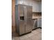 Kitchen with stainless steel refrigerator, gray cabinets, and tiled flooring at 248 Parkview Dr, Whiteland, IN 46184