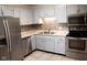 Updated kitchen with stainless appliances, light grey cabinets, and tile flooring at 248 Parkview Dr, Whiteland, IN 46184