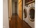 Hallway laundry room with side-by-side washer and dryer and a wooden barn door at 248 Parkview Dr, Whiteland, IN 46184