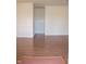 Open concept living room boasts continuous hardwood floors with base trim and white walls at 248 Parkview Dr, Whiteland, IN 46184