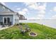 Picturesque backyard with a fire pit, patio seating, lush lawn, and privacy fence, ideal for entertaining at 2536 Maricopa Blvd, Whitestown, IN 46075