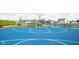 Outdoor basketball court with benches and a backdrop of lush greenery and neighborhood homes at 2536 Maricopa Blvd, Whitestown, IN 46075