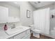 Bright bathroom featuring a large framed mirror, tub/shower combo, and vinyl floors at 2536 Maricopa Blvd, Whitestown, IN 46075
