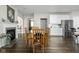 Inviting dining area has wood floors, a glass-top table with chairs, and a fireplace in the background at 2536 Maricopa Blvd, Whitestown, IN 46075