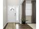 Bright entryway featuring wood floors, a white door, and natural light from a nearby window at 2536 Maricopa Blvd, Whitestown, IN 46075