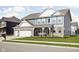 Charming two-story home featuring a landscaped front yard, porch with seating, and a two-car attached garage at 2536 Maricopa Blvd, Whitestown, IN 46075