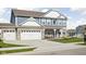 Charming two-story home featuring a landscaped front yard, covered porch with seating, and a two-car attached garage at 2536 Maricopa Blvd, Whitestown, IN 46075