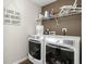 Functional laundry room with modern washer and dryer and storage shelves for laundry supplies at 2536 Maricopa Blvd, Whitestown, IN 46075