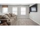Cozy living room offers natural light, neutral paint tones, and plush carpet floors at 2536 Maricopa Blvd, Whitestown, IN 46075