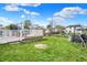 Expansive backyard with a deck, shed, trampoline, and ample green space, offering endless possibilities at 3110 S Temple Ave, Indianapolis, IN 46237